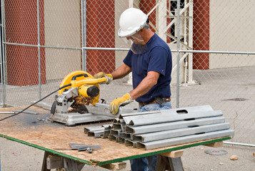 Worker Cutting Metal Studs