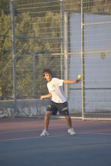 Boy plays tennis