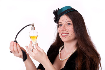Woman in 1920s costume with perfume bottle