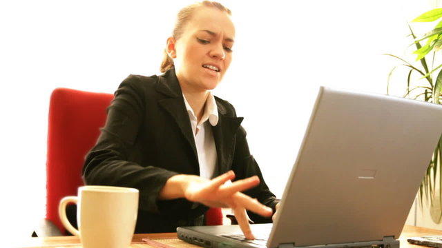 Frustrated businesswoman with laptop, slow motion