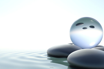 Zen stones and glass sphere on white background