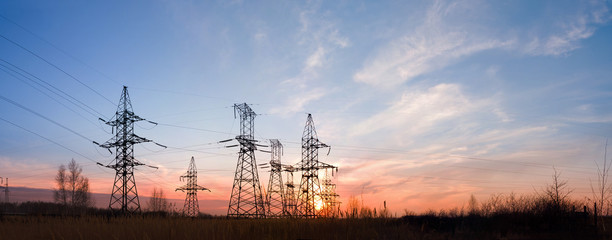 Electricity pylons and lines at dusk.