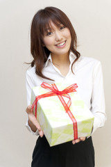 a portrait of young woman taking a present