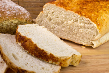 Homemade bread on a breadboard with a breadknife