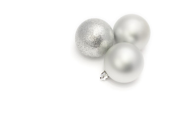 Christmas baubles, three silvery balls on white background