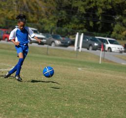 girl playing soccer with focus
