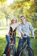 Fototapeta na wymiar Young couple on bikes