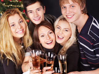Group young people at nightclub by christmas tree.