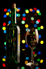 Wine bottle and glass over holiday background