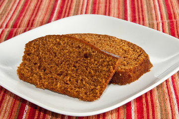 Two slices of freshly baked pumpkin bread on holiday napkin