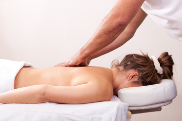 Obraz na płótnie Canvas Young beautiful woman getting back massage