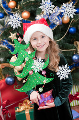 Little girl in Santa hat with Christmas decoration