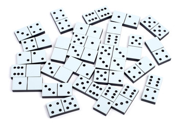 Domino pieces laying on white background randomly