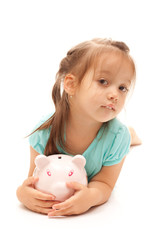 Young little girl holding a piggy bank