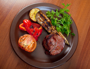 Grilled beef on white plate  with vegetable.