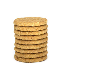 Stack of nine oaty biscuits isolated on white