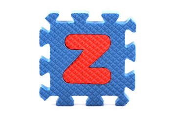 Alphabet puzzle pieces on white background