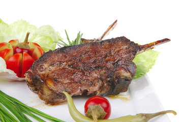 meat plate: roast ribs on white with tomatoes