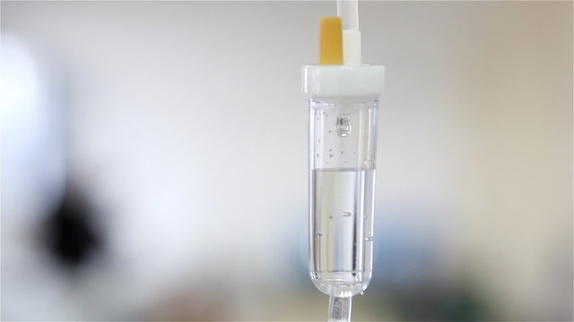 Intravenous drip on white background in operation room