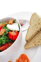 salad with smoked salmon in white bowl