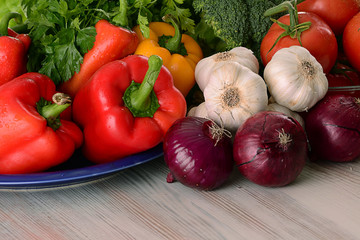 Composition with raw vegetables on kitchen table