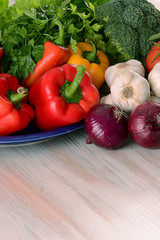 Composition with raw vegetables on kitchen table