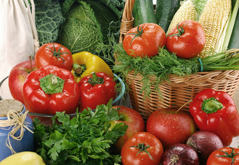 Composition with raw vegetables and wicker basket