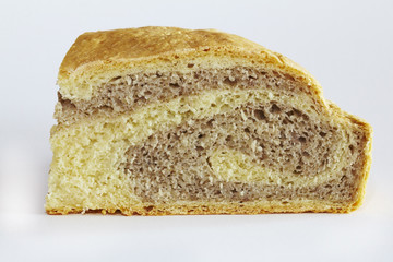 Piece of corn and rye flour bread on a white background