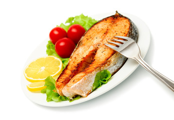 fish steak with vegetables on white background