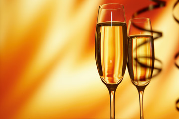 Glass of champagne against golden background
