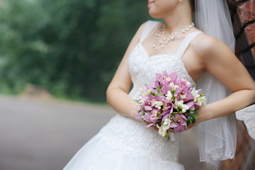 Bride holding pink wedding flowers bouquet