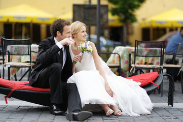 Bride and groom sitting in on a branch