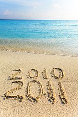 On sand at ocean edge it is written 
