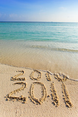 New 2011. The wave washes off an inscription 2010.