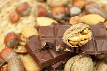bar of chocolate and nuts on a wicker mat