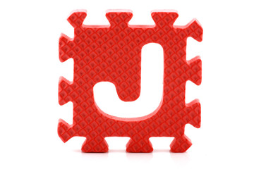 Alphabet puzzle pieces on white background