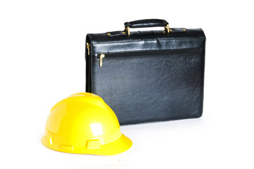 Construction concept - case and hard hat isolated on white