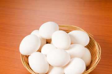 Many white eggs on the wooden table