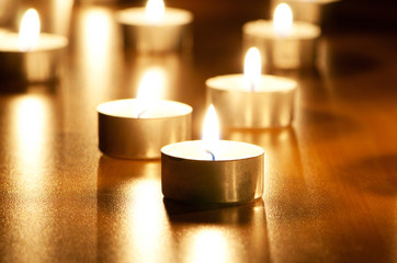 Many burning candles with shallow depth of field