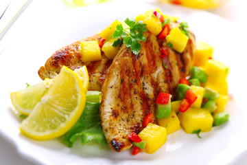 Grilled chicken breast with fresh mango salsa, soft focus