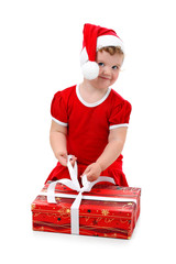 Baby girl in Santa hat unpacking her Christmas present isolated