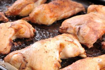 Close-up image of a roasted chicken leg on tray