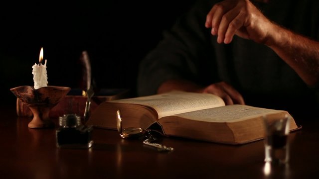 Old book with hands