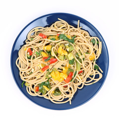 Spaghetti with vegetables on a plate on white background