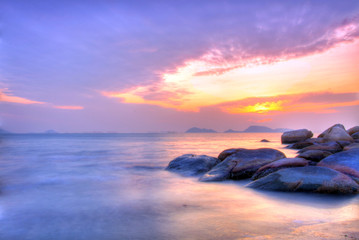 Fototapeta na wymiar Sea and rock at the sunset under long exposure.