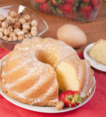 sliced cake with a strawberry and nuts