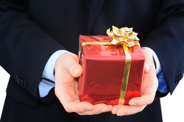 Well-dressed businessman is giving a present