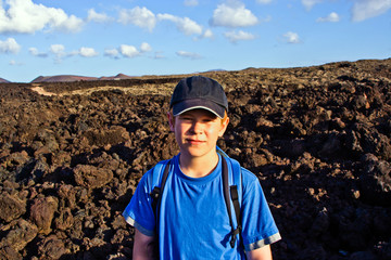 young boy walking through volcanic area in Lanzarote