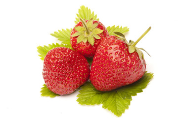 Three strawberries with leaf isolated on white