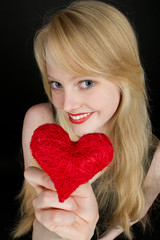 Beautiful young blond girl with heart